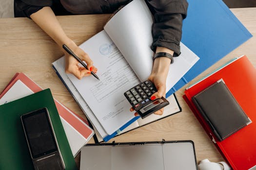 a calculator and tax documents on a desk