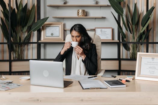 person organizing paperwork at a desk