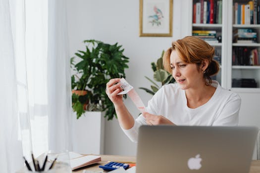 person analyzing expenses on a laptop