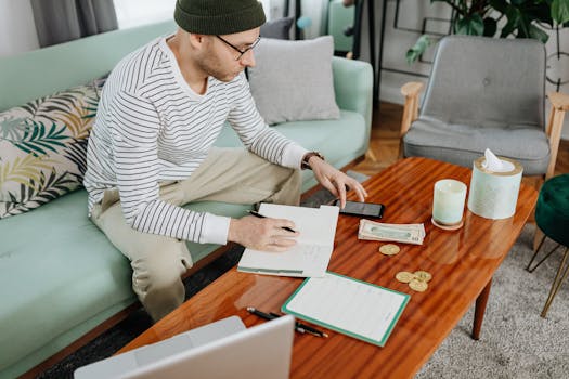 A person organizing their finances on a laptop